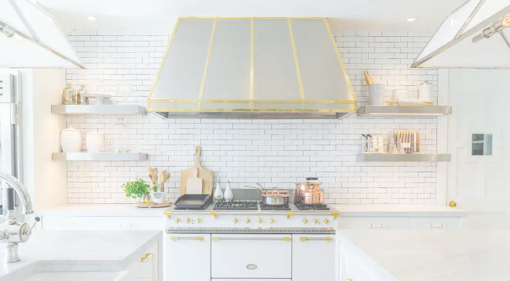 A beautiful, airy light kitchen with items displayed on shelving.
